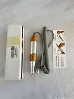 Handpiece, cord, box and instruction card laid out