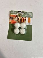 Front of sealed pack showing four white screw glides