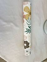 Rolled floral wallpaper showing pattern