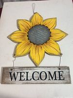 Front view of sunflower wall sign showing design and wire hanger