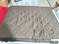 folded brown quilted cover showing diamond stitching