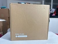 Front view of sealed box labeled Baby Scale with URL