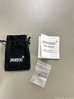Velvet JFORYOU pouch, instruction leaflet, clear zip bag with jewelry pieces