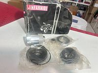 Box front and contents: metal tool, two sealed bags with seals and O-rings