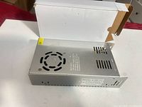 Top view showing cooling fan, vents and label indications on metal case