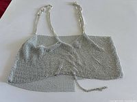 Front view of silver rhinestone mesh crop top with chain straps
