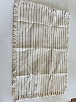 Front view of striped woven textile with fringe