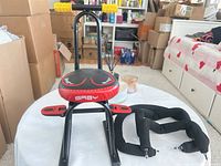 Front view of ride-on toy showing seat, frame, handlebars, footrests, and strap