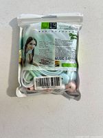 Front view of sealed U19 earbud package showing product inside