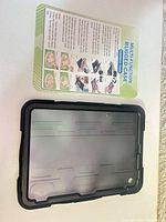 Front frame of black rugged tablet case next to installation guide card