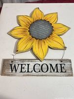 Front view of sunflower wall sign showing design, text, and hardware