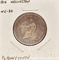 Full view of coin in cardboard flip with written identifiers