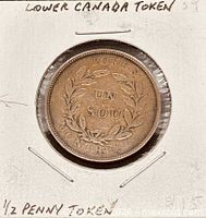 Obverse view of token showing wreath and legends