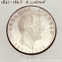 Obverse of medallion showing Abraham Lincoln portrait and dates