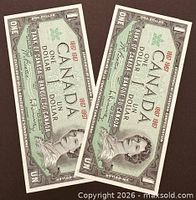 Obverse view of both uncirculated 1967 Centennial $1 notes showing Queen Elizabeth II portrait and consecutive serials