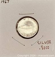 Coin in cardboard holder marked 1967 and .800 silver