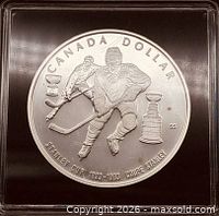 Reverse showing hockey player, Stanley Cup and denomination