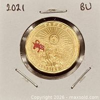 Reverse of coloured 2021 Klondike $1 coin in flip