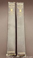 Spine view of both volumes showing titles, volume numbers and publisher