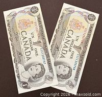 Obverse view of both 1973 $1 notes showing Queen Elizabeth II and serial numbers