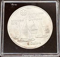 Reverse showing sailboats design, Montréal 1976 text and $5 denomination in holder