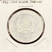 Token obverse in holder labeled 1952-1977 Silver Jubilee