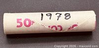Side view of paper coin roll, handwritten 1978 on wrapper