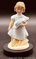 Front view of figurine showing mother holding infant