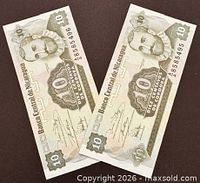 Front faces of both banknotes showing portrait, denomination and serial numbers