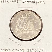 Obverse of nickel medal showing hockey players and 1972-1997 legends in cardboard holder