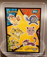 Front of card with six Pokémon characters and Topps logo in clear holder