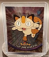 Front of Meowth card in sleeve, showing artwork and card number 52