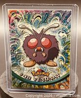 Front of Venonat #48 card in plastic sleeve