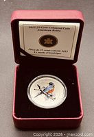 Coin in open presentation case with certificate card