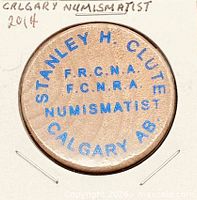 Obverse showing full wording and wood grain