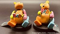 Front view of both wooden Pozy Bears holding BABY letters