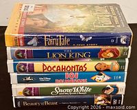 Stack of six VHS tapes showing titles and cases