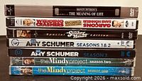 Stack of six unopened comedy DVDs