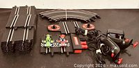 Full set showing track pieces, cars, controllers and adapter