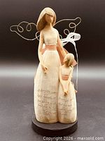 Front view showing full figurine, inscription, colors, and base