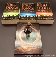 Front view of three paperback novels and Hobbit DVD set with figurine on top