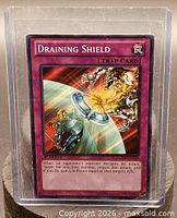 Front of Draining Shield card in sleeve and top-loader