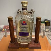 Front view of Crown Royal 1.75L bottle secured in decorative cradle stand