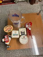 Group shot showing pitcher, coasters and swizzle sticks on table