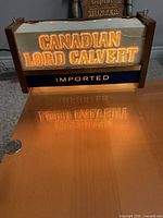 Front view showing illuminated lettering and wood frame
