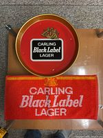 Metal tray and bar towel showing branding and condition