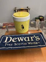 Yellow Dewar's plastic ice bucket and blue rectangular Dewar's tray