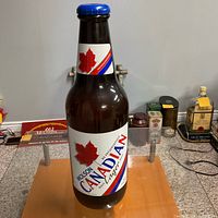 Full view of the 24 in plastic Molson Canadian beer bottle piggy bank