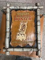 Front view of Seagram's Canadian Hunter molded resin bar sign with faux birch frame and raised hunter graphic