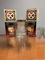 Two boxed Seagram's V.O Collector Series glasses and one loose etched tumbler